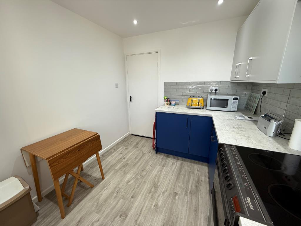 Lot: 1 - TWO-BEDROOM TOP FLOOR APARTMENT IN COASTAL LOCATION - Other view of kitchen showing space for dining